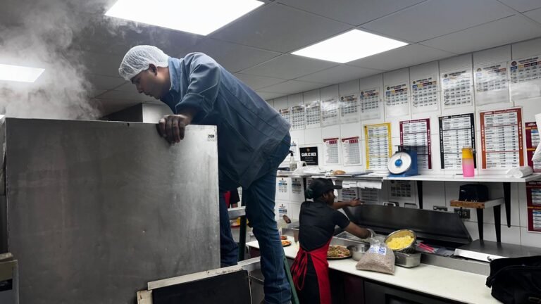 Working on equipment in a busy commercial kitchen
